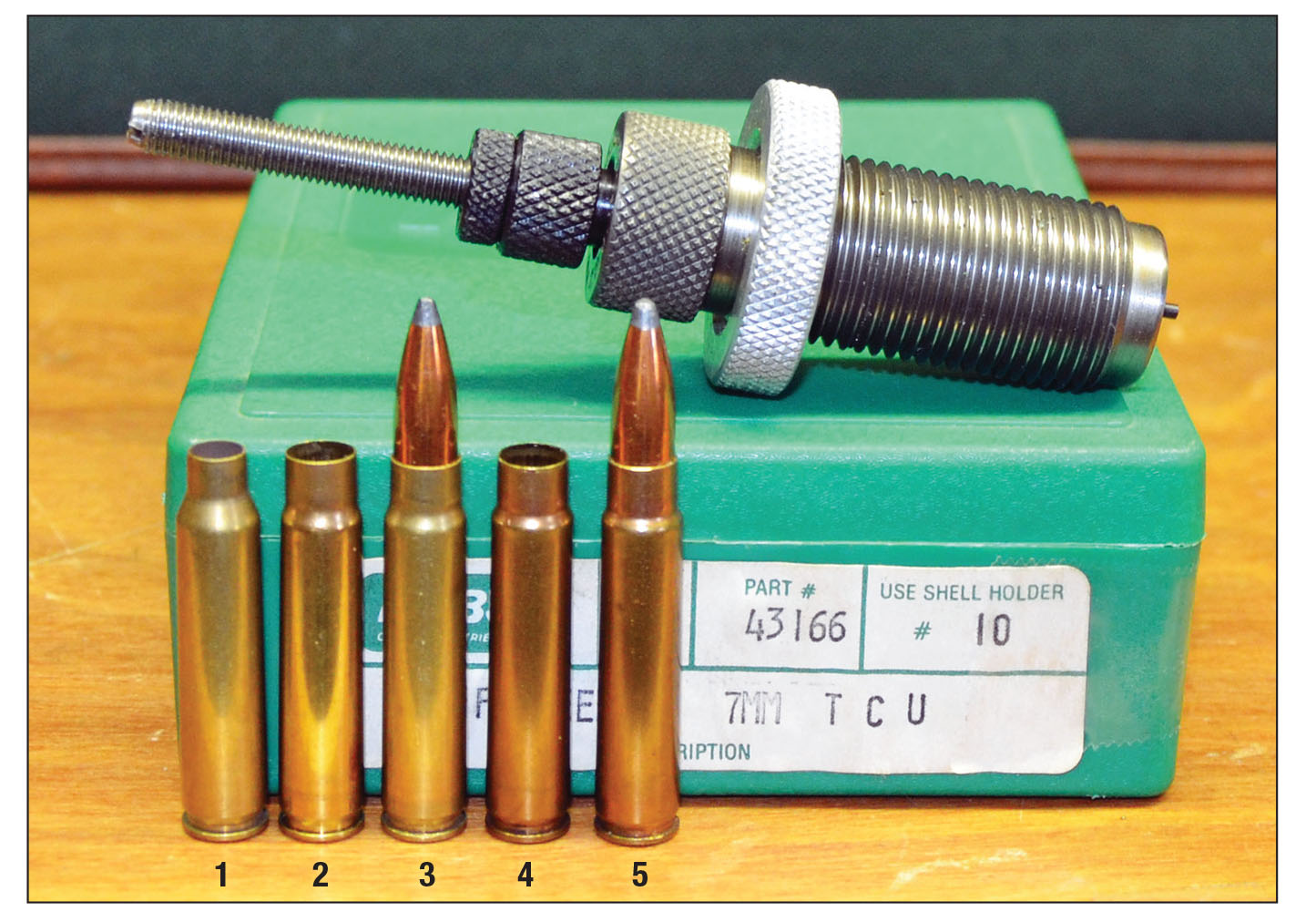 A tapered expander in the RCBS 7mm TCU full-length resizing die increases the neck diameter of the .223 Remington case to 7mm in one step. Cases shown include a (1) .223 Remington case, (2) neck expanded to 7mm, (3) case primed, charged and bullet seated for fireforming, a (4) fireformed case and a (5) loaded 7mm TCU round.